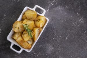 bowl of rustic fried and roasted potatoes with rosemary.