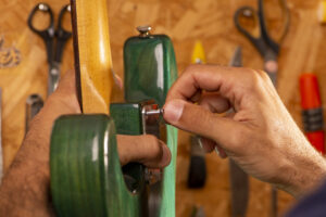 luthier working on repairing a guitar
